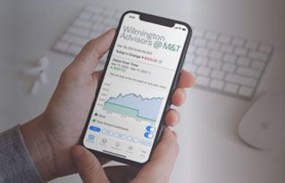 woman in glasses drinking from a mug